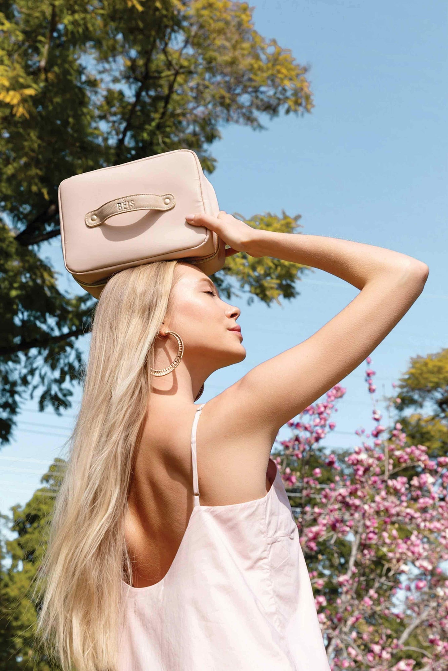 model with hanging cosmetic case in hand
